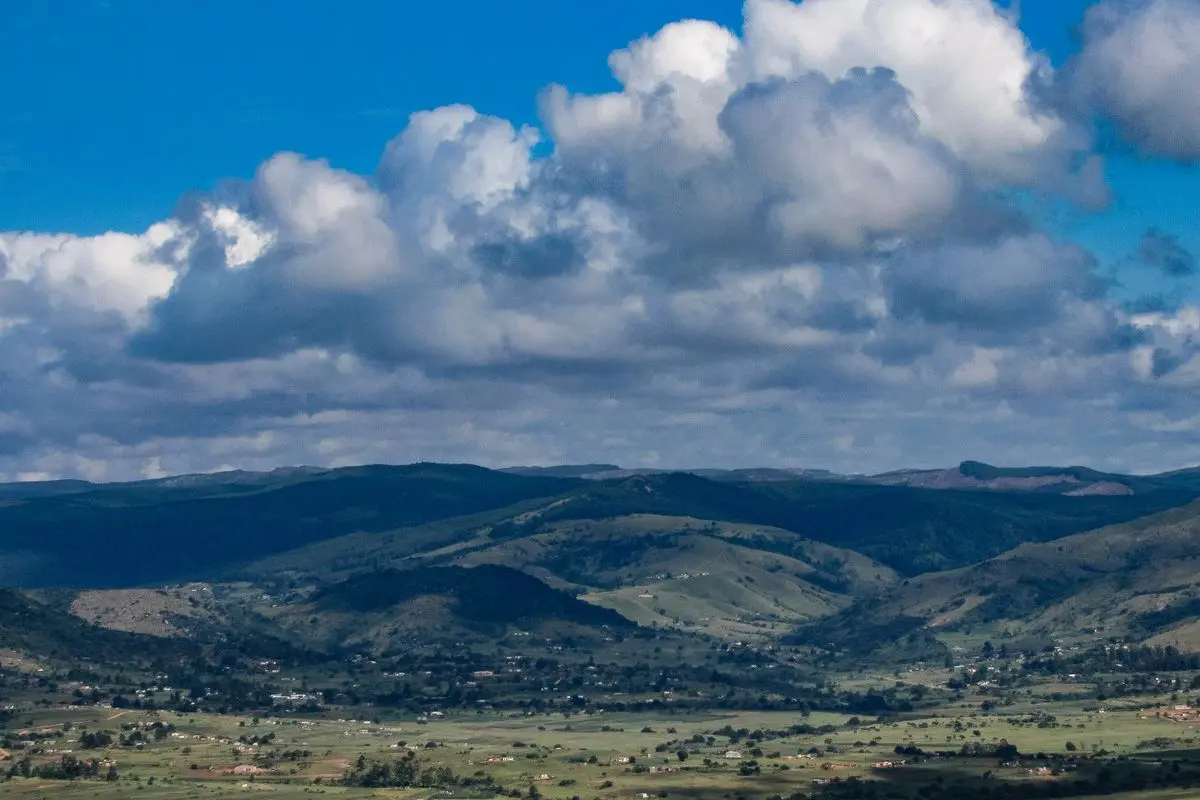 Rolling green hills beneath blue skies in Eswatini