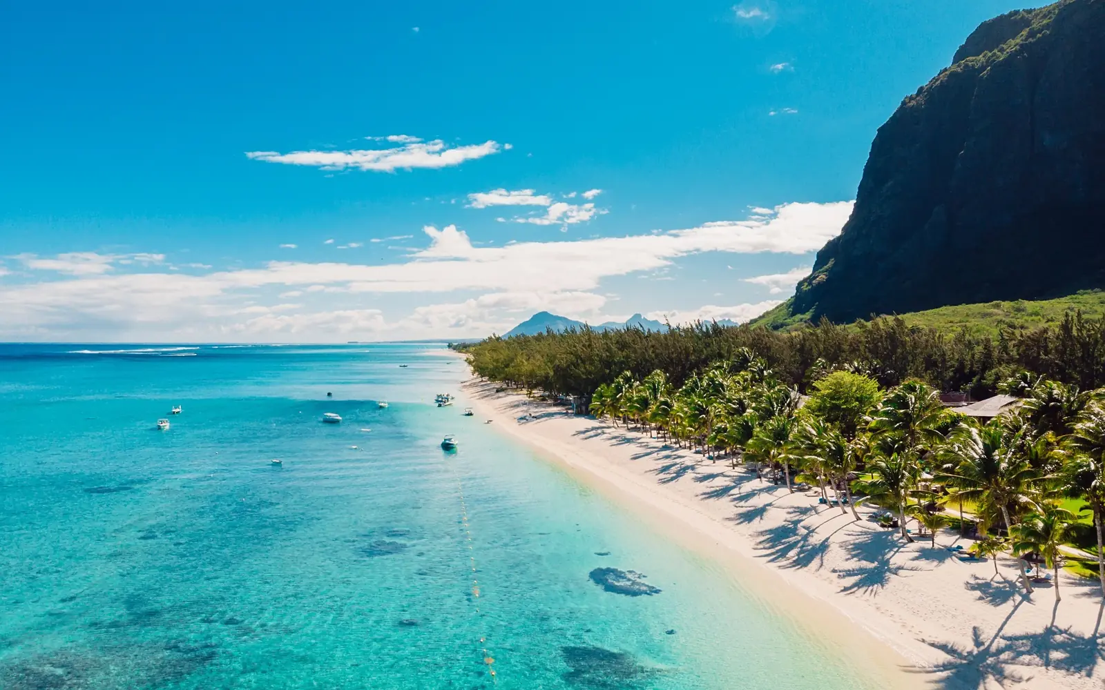 Aerial view of a turquoise lagoon and palm-fringed beach in Mauritius