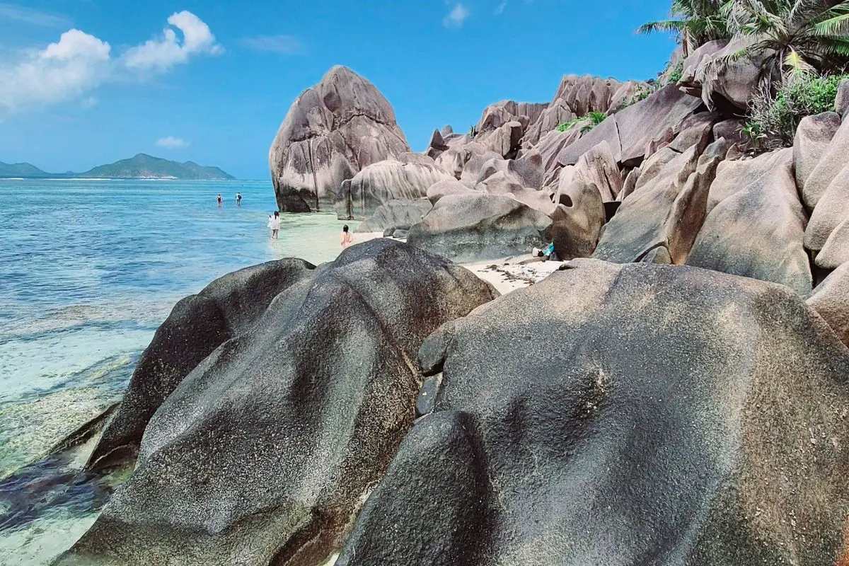 Granite boulders and turquoise water on a beach in the Seychelles